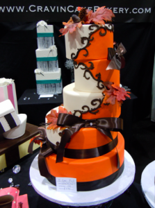 multi-tiered wedding cake in orange, chocolate, and cream colors