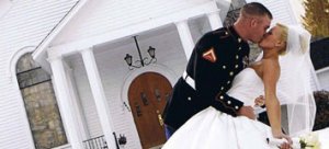 Military groom kisses his bride