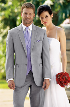 Man in light gray tuxedo with lavender tie, vest, and pocket square