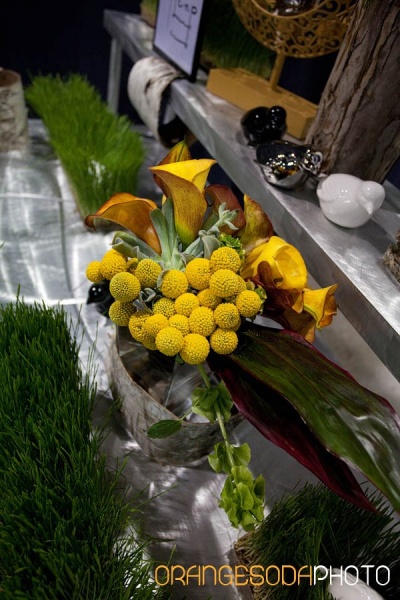 bridal bouquet of yellow flowers, sage, leaves, and yellow calla lilies with red tips
