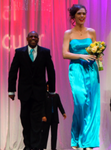 happy groomsman in black tux, happy bridesmaid in turquoise dress