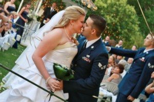 bride and military groom kiss