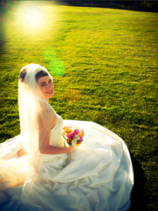bride sitting on grass