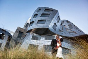 bride and groom at reflective building
