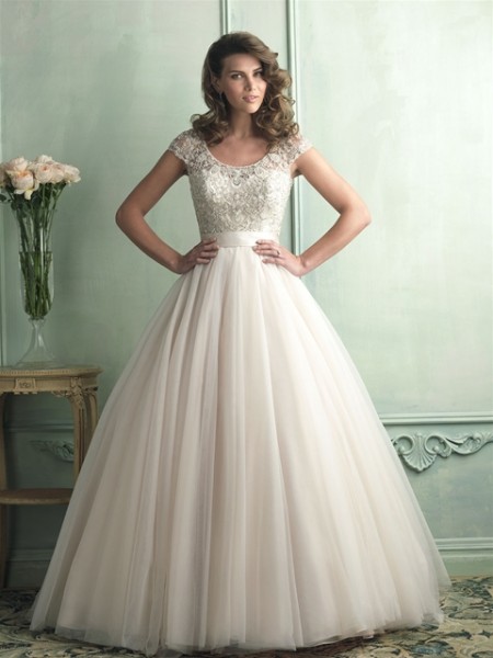 Allure Bridals English net ball gown with beaded bodice and capped sleeves .