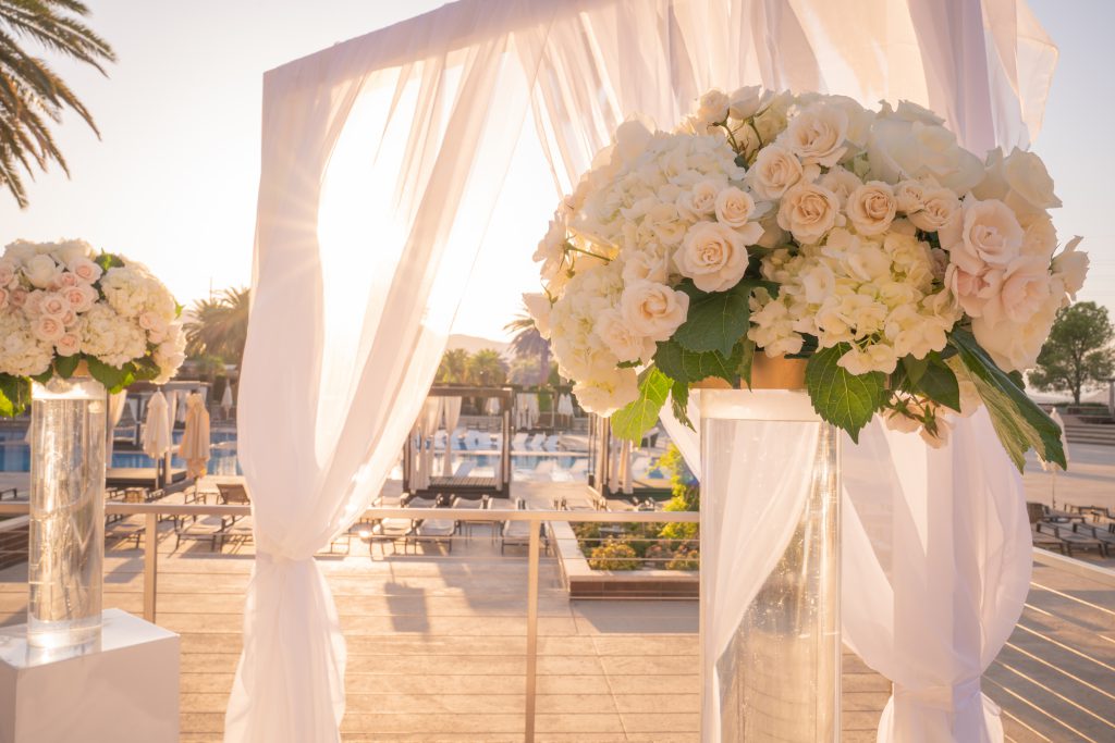 White flowers outdoor ceremony at a luxurious las vegas destination wedding.