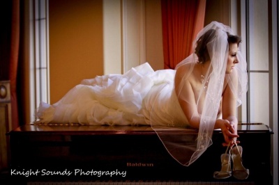 bride lying atop piano
