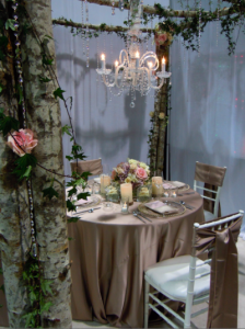 woodland display with roses, ivy, and crystal chandelier